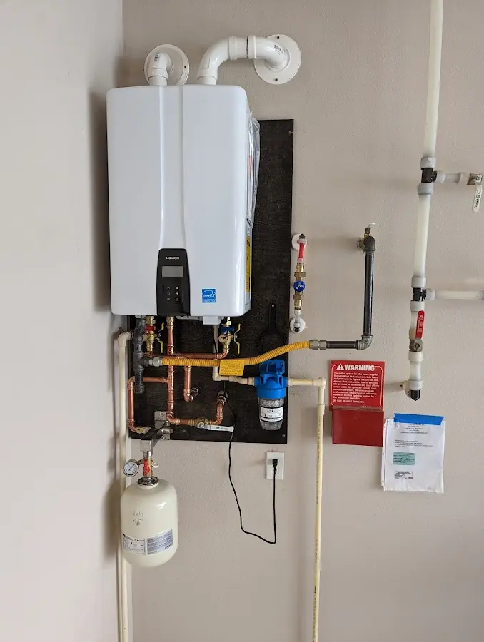 Professional plumber installing copper piping in a Nome home